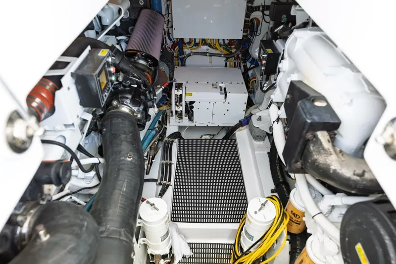 Slide: The Image of Engine room of 2018 Hatteras GT45X Flybridge, showcasing mechanical components and wiring. - 47