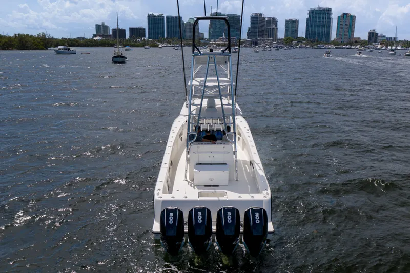 Slide: The Image of 2017 SeaVee 390 boat with four outboard engines on a bustling waterway. - 1