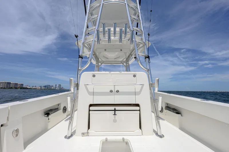 Slide: The Image of 2017 SeaVee 390 boat with tower, ocean view, and city skyline in the background. - 4