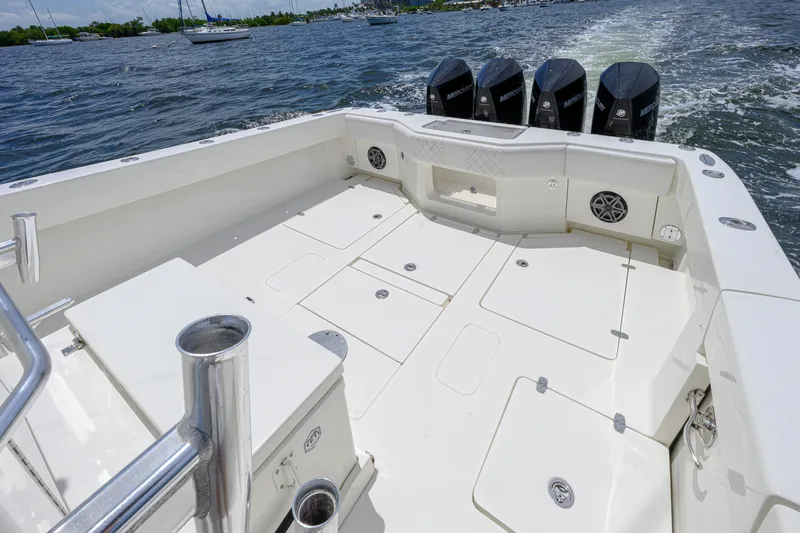 Slide: The Image of 2017 SeaVee 390 boat deck with multiple storage compartments and four outboard motors. - 6