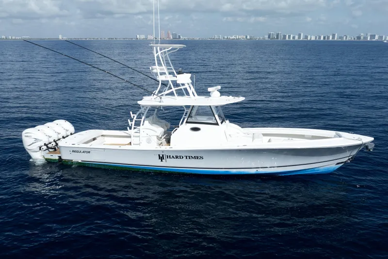 Slide: The Image of 2020 Regulator motor yacht on open water, featuring triple Yamaha engines. - 1