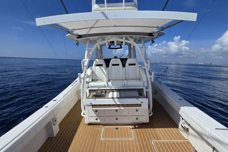 Slide: The Image of 2020 Regulator Motor Yacht on open sea, featuring spacious deck and seating. - 10