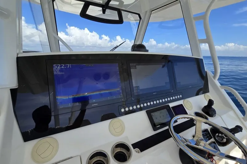 Slide: The Image of Control panel of 2020 Regulator Motor Yacht with navigation screens and steering wheel. - 11