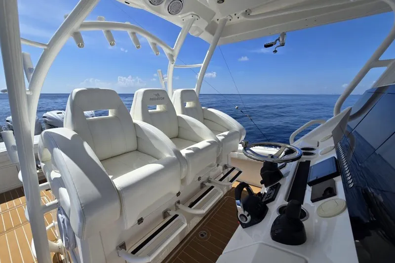 Slide: The Image of Luxurious 2020 Regulator Motor Yacht interior with white seating and ocean view. - 12