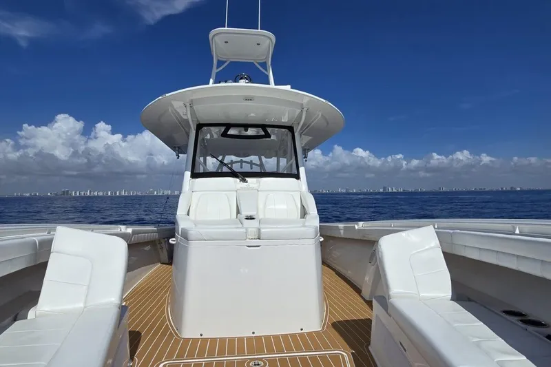 Slide: The Image of 2020 Regulator Motor Yacht on open sea with clear skies and city skyline. - 14