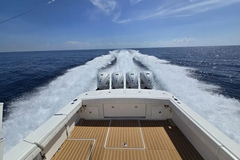 Slide: The Image of 2020 Regulator Motor Yacht cruising on open sea, leaving a wake behind. - 15