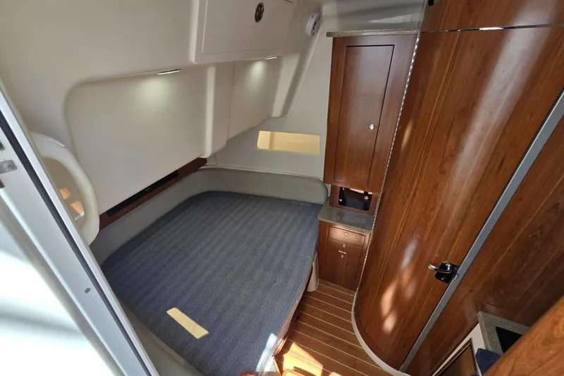 Slide: The Image of 2020 Regulator Motor Yacht interior cabin with bed, wooden cabinetry, and modern design. - 18