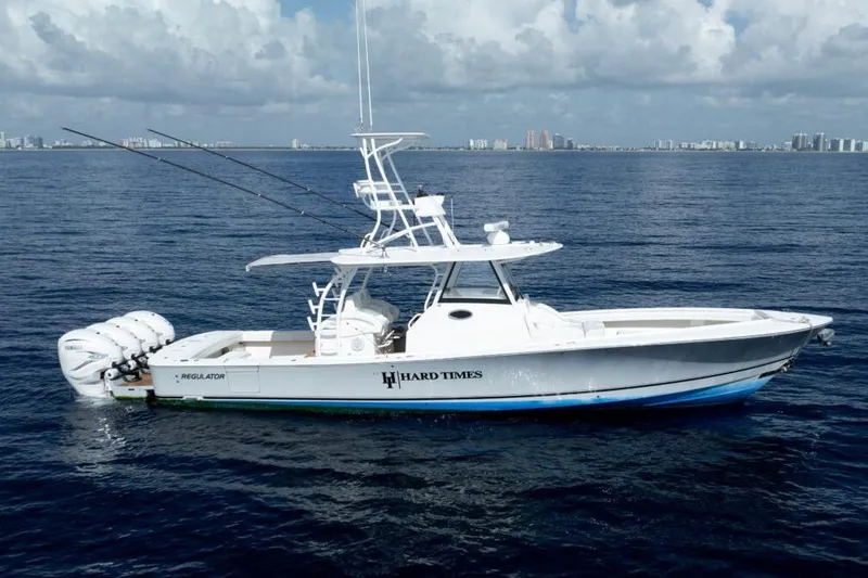 Slide: The Image of 2020 Regulator motor yacht on open water, featuring triple outboard engines. - 2