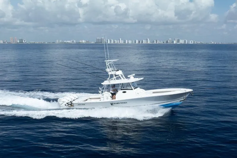 Slide: The Image of 2020 Regulator Motor Yacht cruising on open water with city skyline in background. - 25