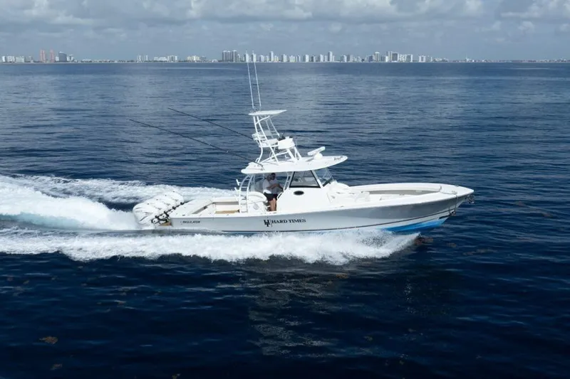Slide: The Image of 2020 Regulator motor yacht cruising on open water with city skyline in background. - 26