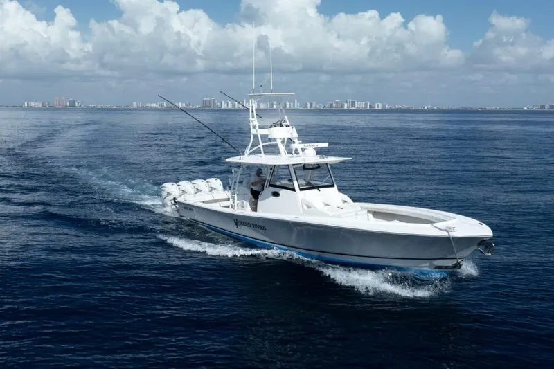 Slide: The Image of 2020 Regulator Motor Yacht cruising on open water under a partly cloudy sky. - 27