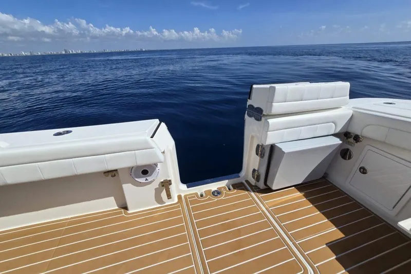Slide: The Image of 2020 Regulator Motor Yacht deck with ocean view, featuring white seating and teak flooring. - 3