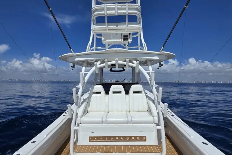Slide: The Image of 2020 Regulator Motor Yacht on calm ocean, clear sky, and distant city skyline. - 4
