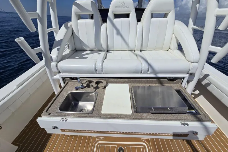 Slide: The Image of 2020 Regulator Motor Yacht with white seating, sink, and grill on deck. - 9