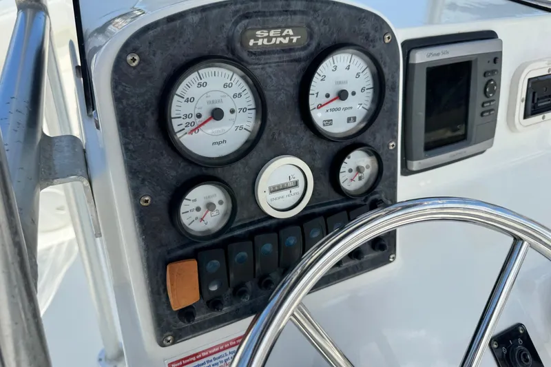 Slide: The Image of Dashboard of 2008 Sea Hunt 220 Triton boat with gauges and steering wheel. - 10