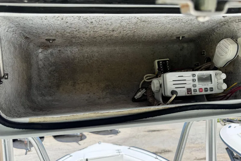 Slide: The Image of Storage compartment with radio equipment on a 2008 Sea Hunt 220 Triton boat. - 14