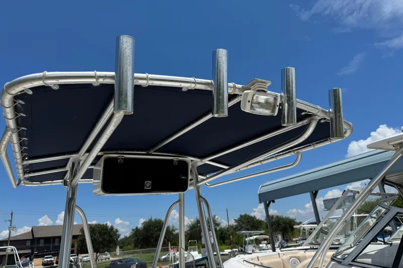 Slide: The Image of T-top of 2008 Sea Hunt 220 Triton boat with rod holders under clear blue sky. - 20