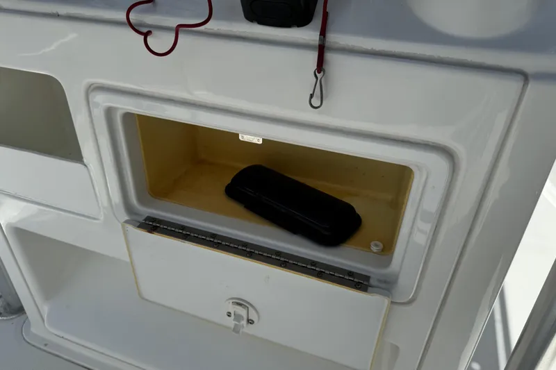 Slide: The Image of Storage compartment on a 2008 Sea Hunt 220 Triton boat with a black case inside. - 21