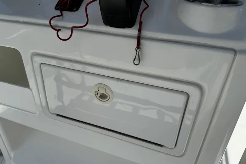 Slide: The Image of Console storage compartment on a 2008 Sea Hunt 220 Triton boat. - 22
