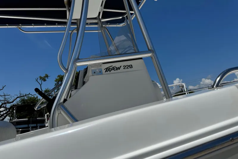 Slide: The Image of 2008 Sea Hunt 220 Triton boat with sleek design and clear blue sky background. - 26