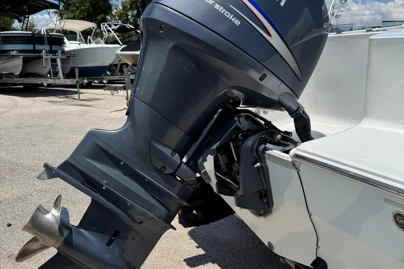 Slide: The Image of Outboard motor on a 2008 Sea Hunt 220 Triton boat, parked on a sunny day. - 28