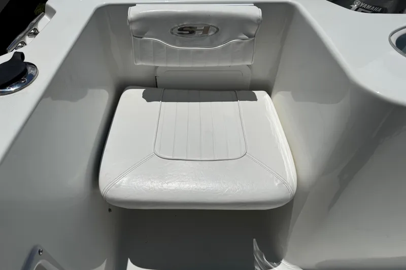 Slide: The Image of White seat on 2008 Sea Hunt 220 Triton boat, featuring sleek design and comfortable padding. - 4