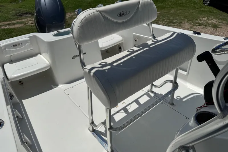 Slide: The Image of 2008 Sea Hunt 220 Triton boat interior with white seating and steering console. - 7