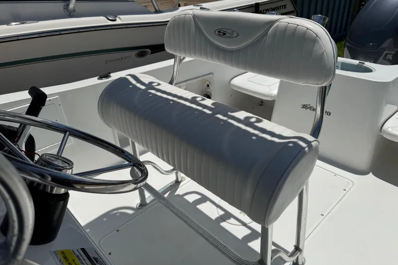 Slide: The Image of 2008 Sea Hunt 220 Triton boat interior with steering wheel and cushioned seating. - 8