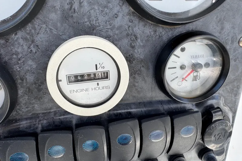Slide: The Image of Close-up of 2008 Sea Hunt 220 Triton dashboard showing engine hours and fuel gauge. - 9