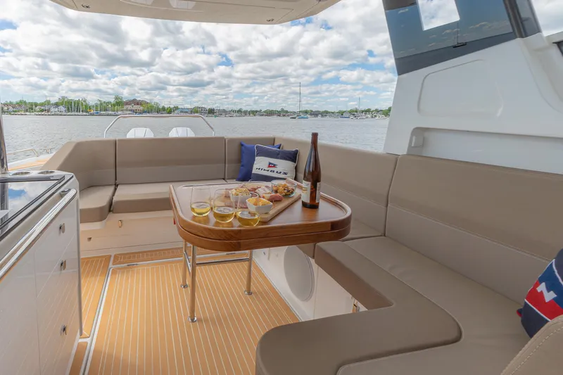 Slide: The Image of Luxurious Nimbus W11 #46 yacht interior with dining setup, overlooking serene waters, 2025 model. - 15