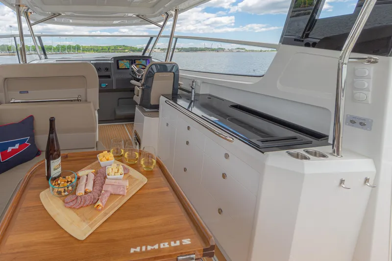 Slide: The Image of Luxurious Nimbus W11 #46 yacht interior with charcuterie board and scenic water view, 2025 model. - 16
