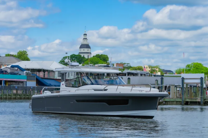 Slide: The Image of Nimbus W11 #46 boat on water with cityscape and cloudy sky background. - 31