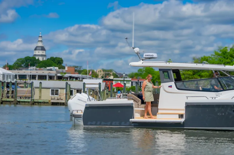 Slide: The Image of Nimbus W11 #46 yacht on water near a scenic harbor with historic architecture, 2025 model. - 32