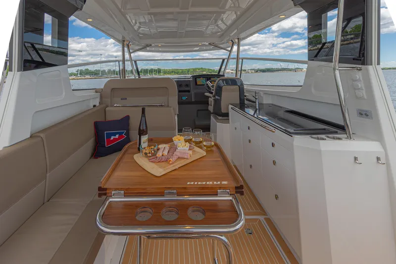 Slide: The Image of Luxurious 2025 Nimbus W11 #46 yacht interior with dining setup and scenic water view. - 33