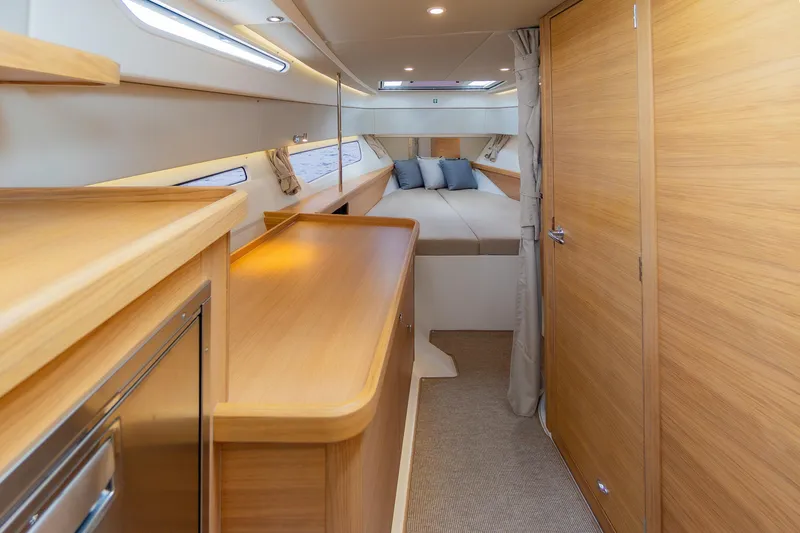 Slide: The Image of Luxurious interior of 2025 Nimbus W11 #46 yacht with wooden finishes and cozy bedding. - 39