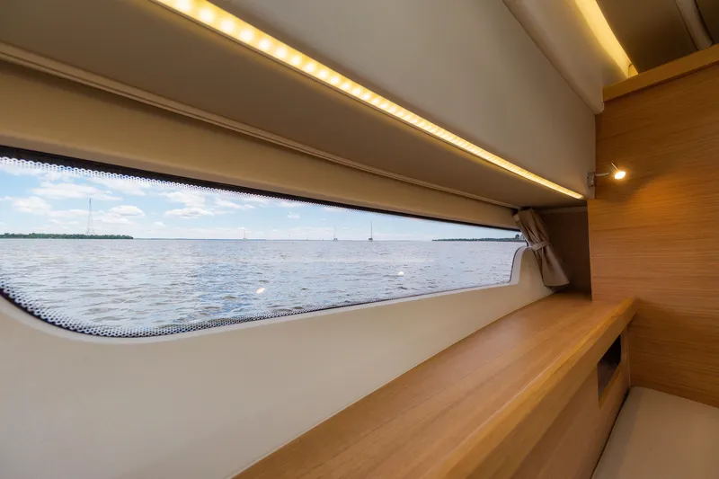 Slide: The Image of Interior view of Nimbus W11 #46 yacht, showcasing window with scenic water view, 2025 model. - 41