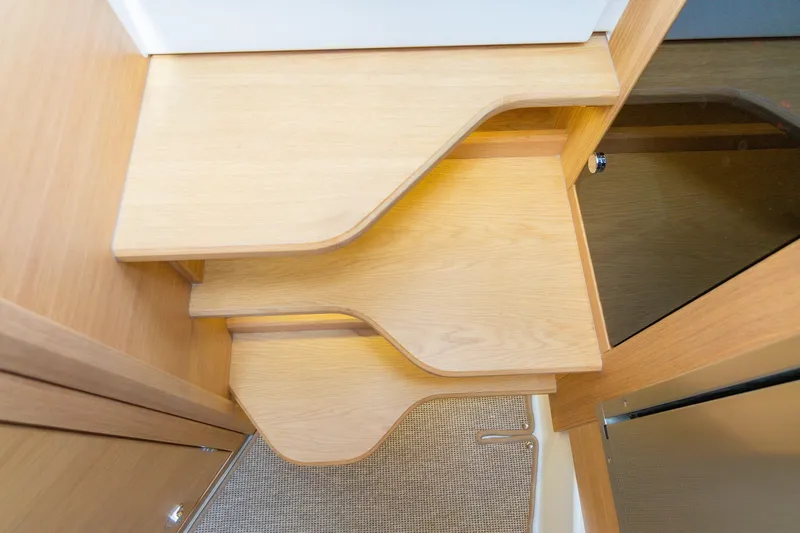 Slide: The Image of Wooden interior stairs in a 2025 Nimbus W11 #46 boat, featuring modern design. - 45
