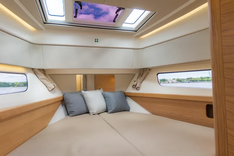 Slide: The Image of Luxurious interior cabin of 2025 Nimbus W11 #46 yacht with skylight and cozy bedding. - 46
