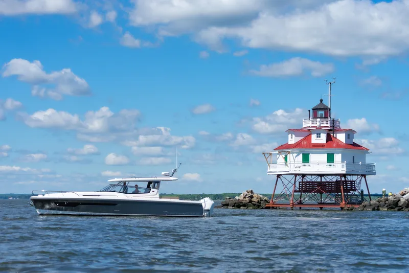 Slide: The Image of Nimbus W11 #46 boat near a historic lighthouse on a sunny day, 2025. - 5