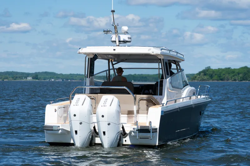 Slide: The Image of Nimbus W11 #46 2025 motorboat cruising on a lake under a clear blue sky. - 58