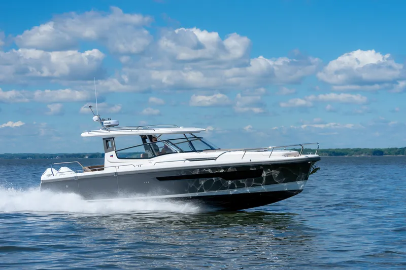 Slide: The Image of 2025 Nimbus W11 #46 motorboat cruising on a sunny day with blue skies. - 59