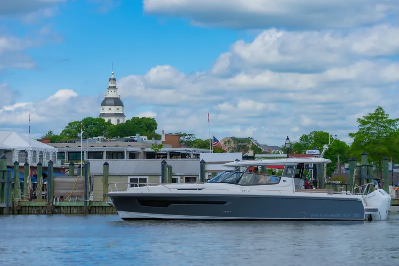 Slide: The Image of Nimbus W11 #46 boat docked near historic building, under blue sky, 2025 model. - 62