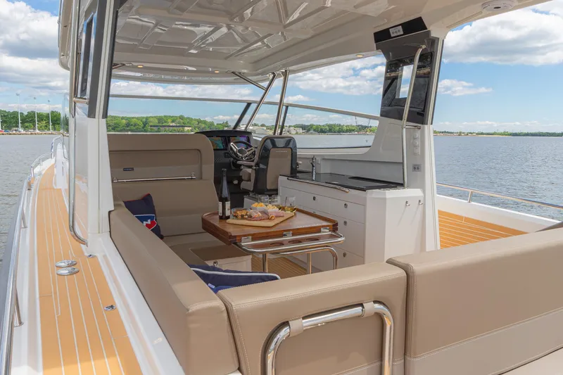 Slide: The Image of Luxurious 2025 Nimbus W11 #46 yacht interior with seating, table, and scenic water view. - 67