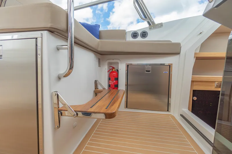 Slide: The Image of Interior of 2025 Nimbus W11 #46 boat with seating, fire extinguisher, and storage. - 72