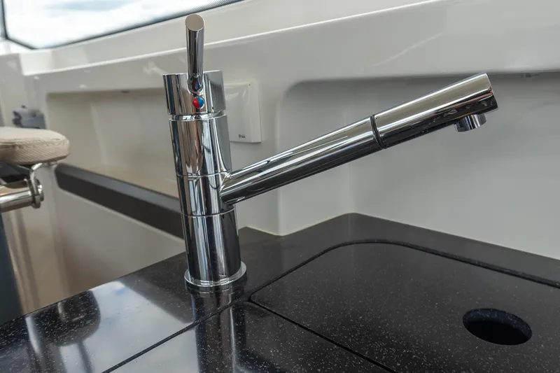 Slide: The Image of Sleek chrome faucet on a modern black countertop in Nimbus W11 #46, 2025 model. - 76