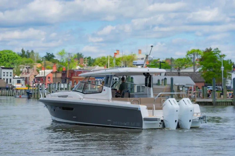Slide: The Image of Nimbus W11 #46 boat cruising near a scenic waterfront, 2025 model. - 9