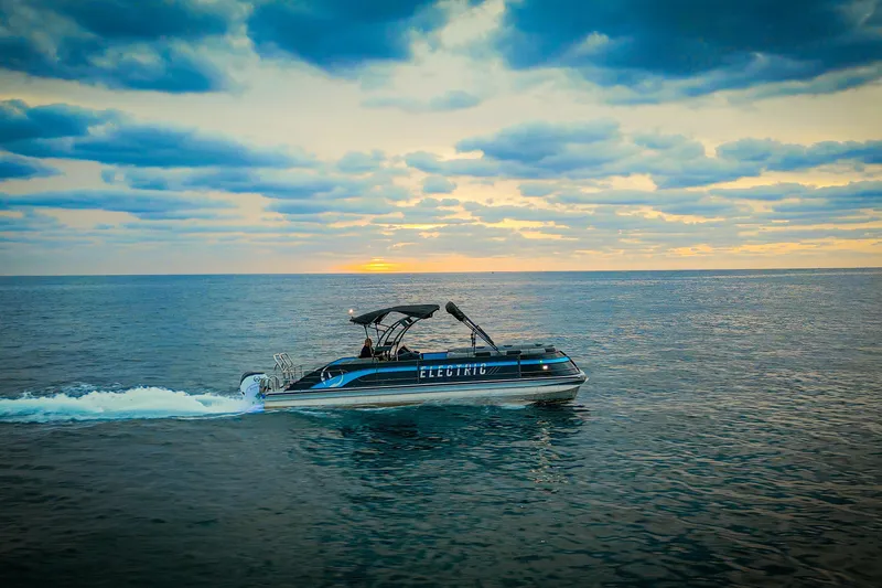 Slide: The Image of Electric Vision Marine Technologies V30 boat cruising at sunset, 2025 model. - 6