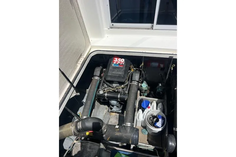 Slide: The Image of Engine compartment of a 1997 Silverton 351 Sedan with visible components and storage. - 12
