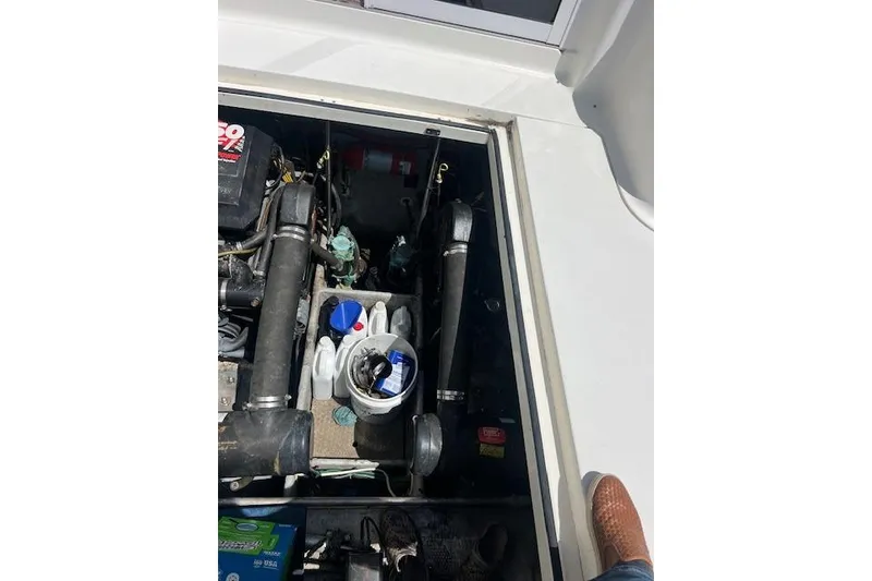 Slide: The Image of Engine compartment of a 1997 Silverton 351 Sedan boat with visible components and supplies. - 13