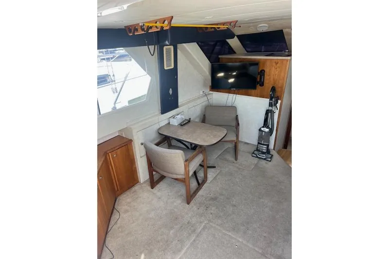 Slide: The Image of Interior of 1997 Silverton 351 Sedan with seating, table, and TV. - 14